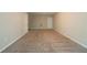 This is a large unfinished basement with carpeted floors and white doors at 297 Edison Dr, Stockbridge, GA 30281