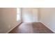 A standard bedroom with a plush neutral carpet, white walls, and a single window at 297 Edison Dr, Stockbridge, GA 30281