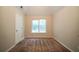 A basic bedroom with beige walls, plush carpeting, standard window, and a single entry door at 297 Edison Dr, Stockbridge, GA 30281