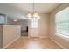 Dining area showcasing a chandelier, window, and adjacent living space at 297 Edison Dr, Stockbridge, GA 30281