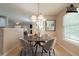 Bright dining area with stylish chandelier, seating for four, neutral walls, and lovely natural light at 297 Edison Dr, Stockbridge, GA 30281