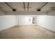 Spacious two-car garage interior with concrete flooring, overhead lights, and white walls at 297 Edison Dr, Stockbridge, GA 30281