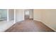 Hallway with neutral walls and carpet, offering multiple access points at 297 Edison Dr, Stockbridge, GA 30281