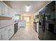 Bright kitchen featuring white cabinets, stainless steel appliances, and ample counter space at 297 Edison Dr, Stockbridge, GA 30281