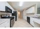 Spacious kitchen featuring stainless steel appliances, white cabinets, and tile flooring at 297 Edison Dr, Stockbridge, GA 30281