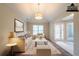 Staged living room with neutral furniture and decor under a vaulted ceiling at 297 Edison Dr, Stockbridge, GA 30281