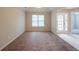 Bright, airy living room with carpet and an arched doorway at 297 Edison Dr, Stockbridge, GA 30281