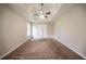 Spacious main bedroom with tray ceiling, neutral paint, carpet flooring, and a window at 297 Edison Dr, Stockbridge, GA 30281