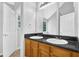 Bathroom with double sinks, granite countertops, and wooden cabinets at 3534 Oakshire Se Way, Atlanta, GA 30354