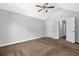 Bright bedroom with neutral carpet, a ceiling fan and a connected bathroom at 3534 Oakshire Se Way, Atlanta, GA 30354