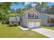 Two-story home with a two-car garage and a green lawn at 3534 Oakshire Se Way, Atlanta, GA 30354