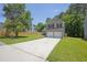 View of a two-story home with a long driveway and green lawn at 3534 Oakshire Se Way, Atlanta, GA 30354