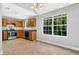 Kitchen with wooden cabinets, modern appliances, tile floor, and window overlooking greenery at 3534 Oakshire Se Way, Atlanta, GA 30354