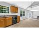 Kitchen featuring light wood cabinets, tile floor, and large window with greenery view at 3534 Oakshire Se Way, Atlanta, GA 30354