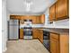 Kitchen with wood cabinets, stainless steel appliances, and tile flooring at 3534 Oakshire Se Way, Atlanta, GA 30354