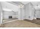 Upstairs living room with views into a kitchen and access to the staircase at 3534 Oakshire Se Way, Atlanta, GA 30354