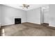 Cozy living room with fireplace, ceiling fan, and neutral carpet at 3534 Oakshire Se Way, Atlanta, GA 30354