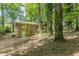 View of home's exterior showing the brick and wood siding in a wooded backyard at 3661 Boring Rd, Decatur, GA 30034