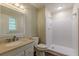 Bathroom featuring a single sink vanity, walk-in shower with a white tiled walls and updated hardware at 3661 Boring Rd, Decatur, GA 30034