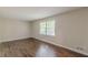 Bedroom with hardwood floors, neutral walls, and a large window at 3661 Boring Rd, Decatur, GA 30034