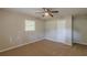 This bedroom features neutral walls, carpeted floor, a ceiling fan, and a white closet door at 3661 Boring Rd, Decatur, GA 30034