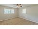 This bedroom features neutral walls, carpeted floor, a ceiling fan, and bright natural light from a double window at 3661 Boring Rd, Decatur, GA 30034