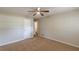 A large bedroom features neutral walls, carpeted floor, a ceiling fan, and a closet door at 3661 Boring Rd, Decatur, GA 30034