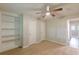 Bedroom featuring neutral walls, ceiling fan, carpet floors, and a built in shelving unit for storage at 3661 Boring Rd, Decatur, GA 30034