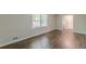 Bedroom with hardwood floors, neutral walls, and large window at 3661 Boring Rd, Decatur, GA 30034