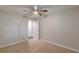 Neutrally decorated bedroom features carpet, a ceiling fan and an open door to a hallway at 3661 Boring Rd, Decatur, GA 30034