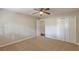 This bedroom features neutral walls, carpeted floor, a ceiling fan, and double closet doors at 3661 Boring Rd, Decatur, GA 30034