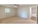 Bedroom featuring neutral walls, carpet flooring, ceiling fan, window, and access to hallway at 3661 Boring Rd, Decatur, GA 30034