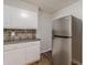 Well-maintained kitchen showcasing white cabinetry, stainless steel fridge and granite countertops at 3661 Boring Rd, Decatur, GA 30034