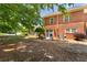 Exterior of brick home featuring a small patio and green space at 3677 Blackshear Ct, Duluth, GA 30096