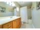Well-lit bathroom with modern sink vanity, matching faucet, commode, and a shower with curtain at 3677 Blackshear Ct, Duluth, GA 30096