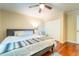 Bedroom featuring a bed, hardwood flooring, ceiling fan, and closet doors at 3677 Blackshear Ct, Duluth, GA 30096