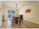 Bright dining room with stylish light fixture, table, and sliding glass doors to the outdoor at 3677 Blackshear Ct, Duluth, GA 30096