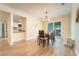 Cozy dining area featuring hardwood floors, a modern chandelier, and an open view to the kitchen at 3677 Blackshear Ct, Duluth, GA 30096