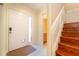 Inviting foyer showcasing wood stairs, tiled floors, and a conveniently located powder room at 3677 Blackshear Ct, Duluth, GA 30096