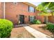 Charming brick townhome featuring a welcoming front entrance with well-maintained landscaping and walkway at 3677 Blackshear Ct, Duluth, GA 30096