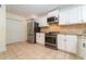 Well-lit kitchen with stainless steel appliances, ample storage, and stylish tile flooring at 3677 Blackshear Ct, Duluth, GA 30096
