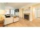 Bright living room featuring hardwood floors, a cozy fireplace, and ample natural light at 3677 Blackshear Ct, Duluth, GA 30096