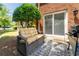 Relaxing patio space with comfortable seating, grill, and a view of the lush backyard and surrounding greenery at 3677 Blackshear Ct, Duluth, GA 30096