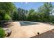 Covered pool with surrounding trees and lounge seating at 3677 Blackshear Ct, Duluth, GA 30096