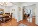 Open concept view of the dining and living rooms; both feature stylish decor and gleaming hardwood floors at 1275 Fontainebleau Ct, Lawrenceville, GA 30043