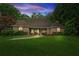 Charming brick home features a manicured lawn, mature trees, and a welcoming entrance for excellent curb appeal at 1275 Fontainebleau Ct, Lawrenceville, GA 30043