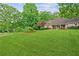 Beautiful front yard boasts a lush green lawn and mature trees adding to the home's curb appeal at 1275 Fontainebleau Ct, Lawrenceville, GA 30043