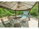 Pool area with shaded gazebo, outdoor seating, and views of the lush surroundings at 1275 Fontainebleau Ct, Lawrenceville, GA 30043