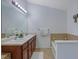 Bright bathroom with double sink vanity, a soaking tub, and neutral tiling for a clean and modern space at 2003 Burns View Ln # 2, Lawrenceville, GA 30044