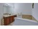 Bright bathroom with double sink vanity, a soaking tub, and neutral tiling for a clean and modern space at 2003 Burns View Ln # 2, Lawrenceville, GA 30044